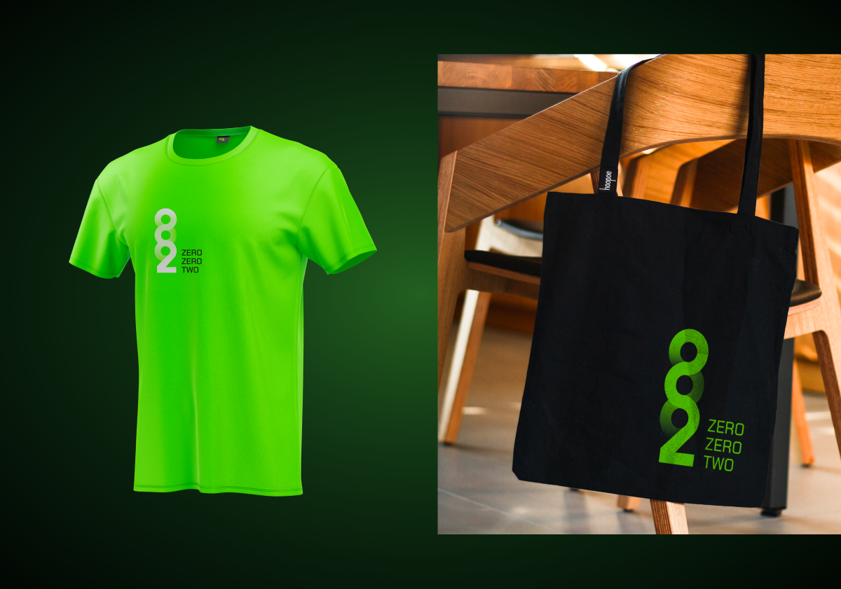 Zero Zero Two logo applied to a green t-shirt and a black tote bag