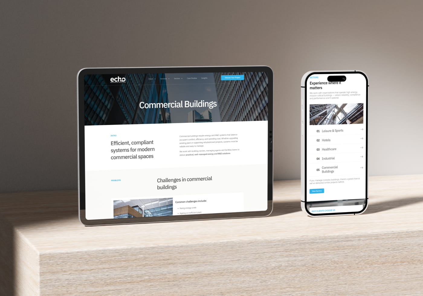 Core Concepts Echo website Commercial Buildings page shown on a tablet beside a phone